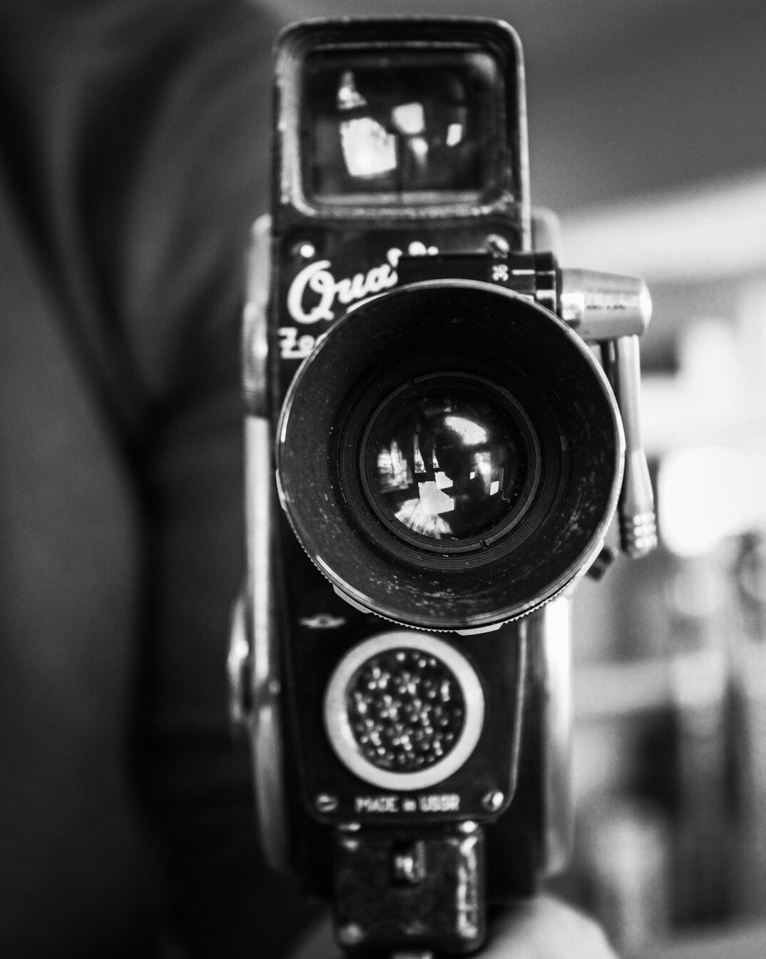 Broadcast camera operator framing a shot in studio